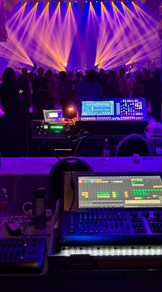 Home Dynamic concert scene with colorful stage lights and sound equipment.